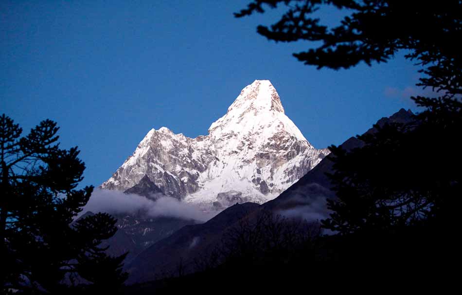 Ama Dablam mountain from far distance surrounded by dark trees near sunset | Hamalayas | Travel Photography | Trekking