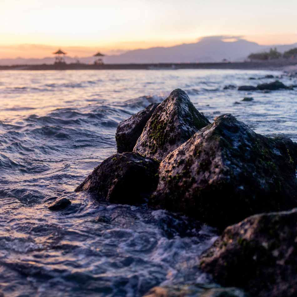 Rocks in water at sunset on beach in Bali, Indonesia | Travel Photography | Nature Photography