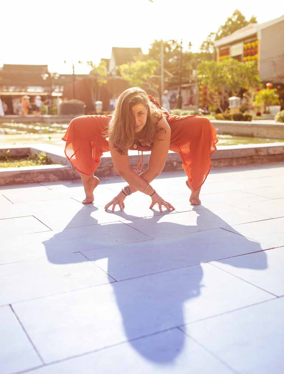 Woman doing a yoga pose outdoors on a sunny day | Hoi An Vietnam